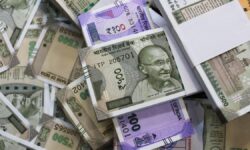 Amid global tumult, Rupee breaches 87 against dollar